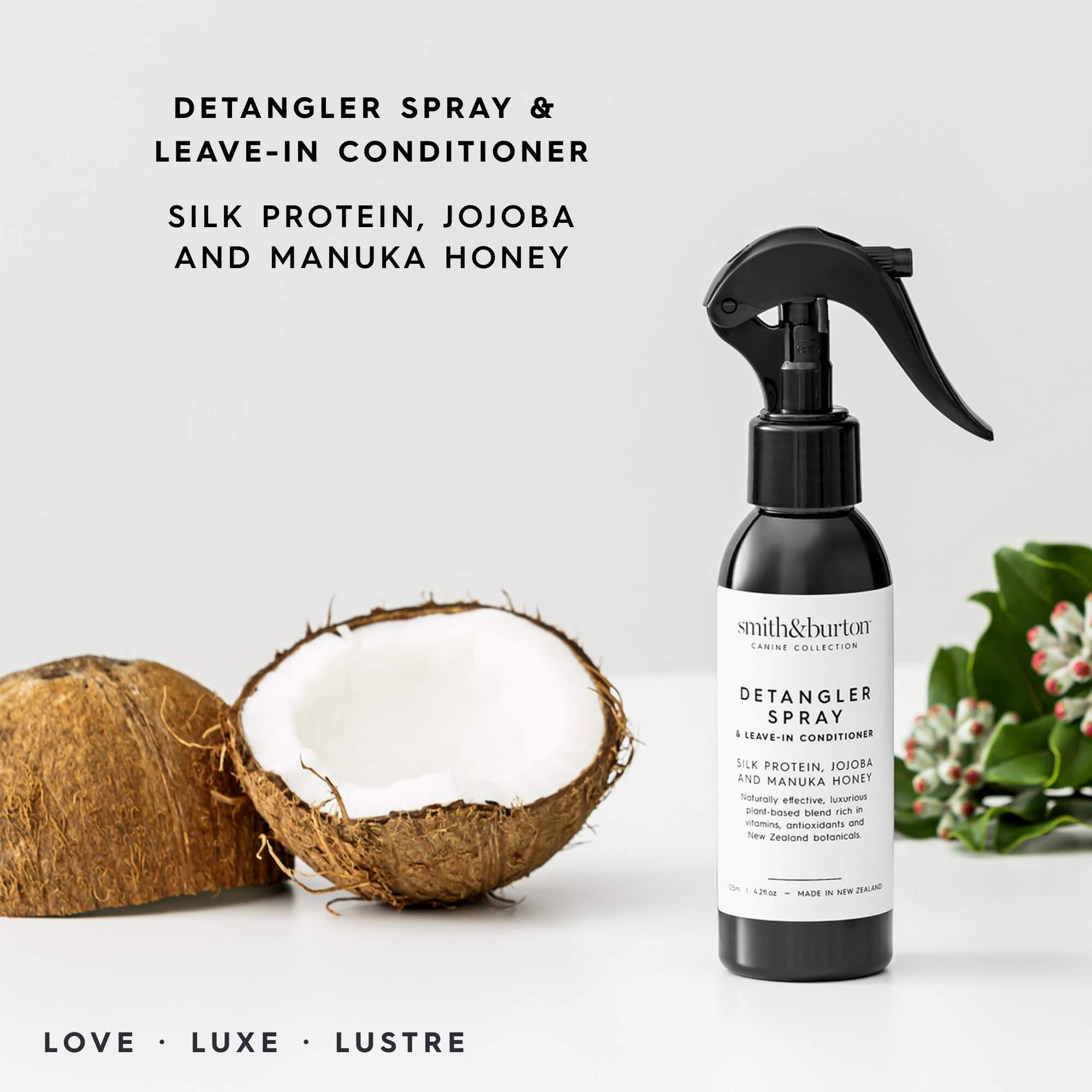 Detangler spray bottle with coconuts and holly leaves on a light background